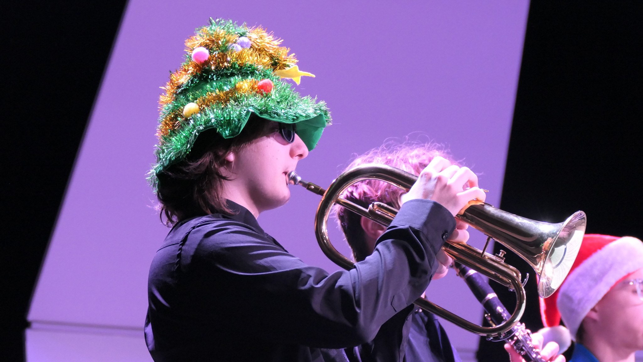 trumpet player wearing sunglasses and a festive hat
